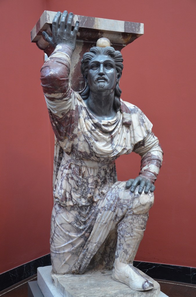 Kneeling_Barbarian_with_coloured_trousers_and_Phrygian_cap,_from_Rome,_ca._20_BC,_Pavonazzetto_marble_from_Asia_Minor,_Ny_Carlsberg_Glyptotek,_Copenhagen_(23502345672)